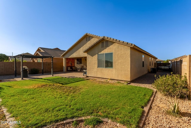 rear view of house with a patio, stucco siding, and central air condition unit