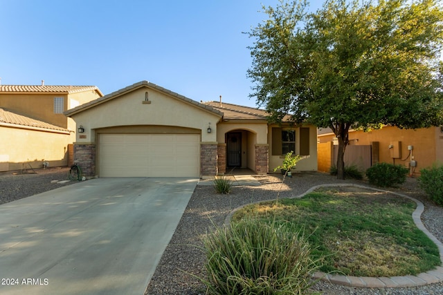 view of front facade featuring stucco siding, a garage, driveway, and stone siding