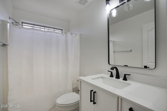 bathroom featuring visible vents, toilet, vanity, and a shower with curtain