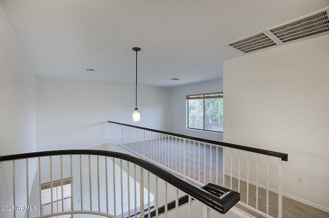 stairway with baseboards and visible vents