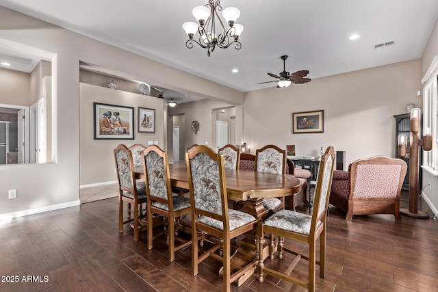 dining room with ceiling fan with notable chandelier and dark wood-type flooring