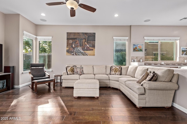 living room with dark hardwood / wood-style flooring and ceiling fan