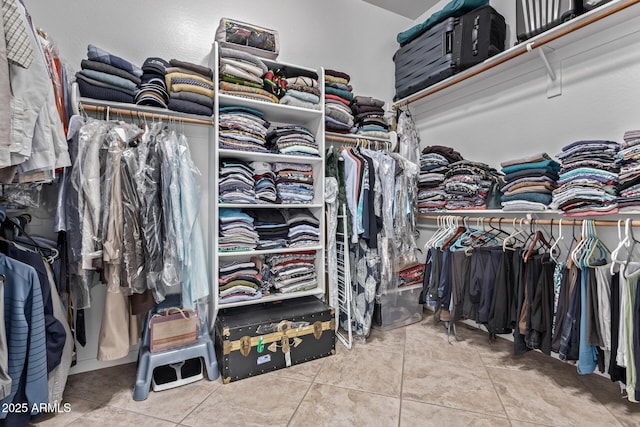 walk in closet with light tile patterned floors