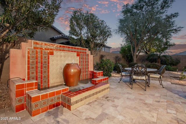 view of patio terrace at dusk