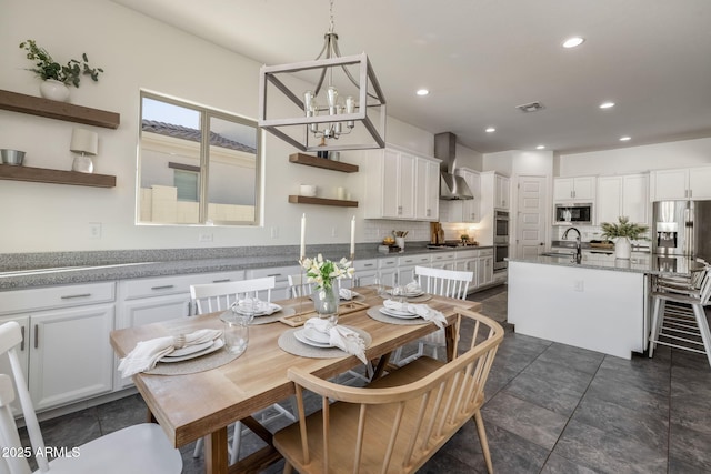 dining space with an inviting chandelier and sink