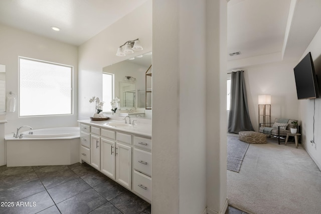 bathroom with vanity, tile patterned flooring, and a bathtub