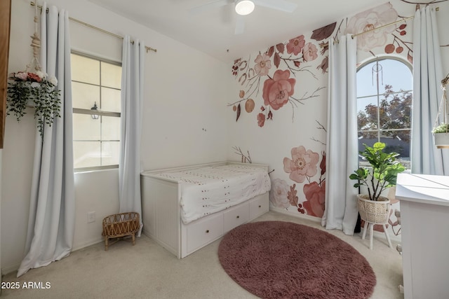 bedroom featuring light carpet and ceiling fan