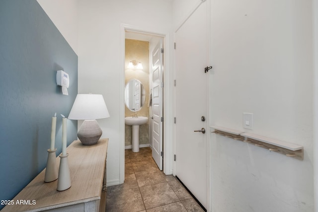 corridor with sink and light tile patterned floors