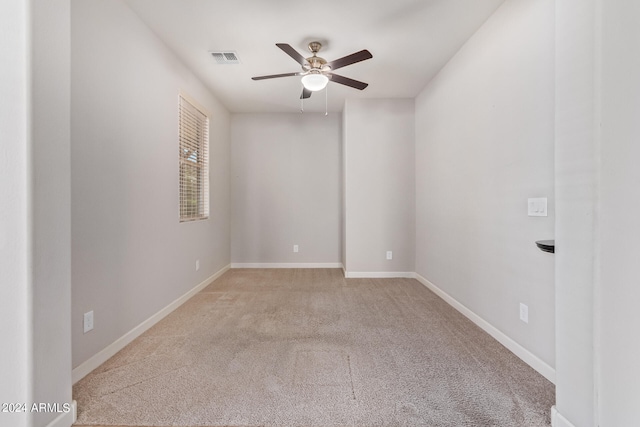 empty room with light colored carpet and ceiling fan