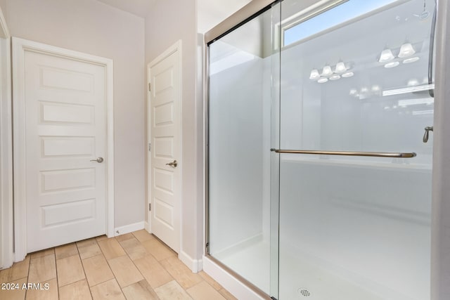 bathroom featuring wood-type flooring and a shower with shower door