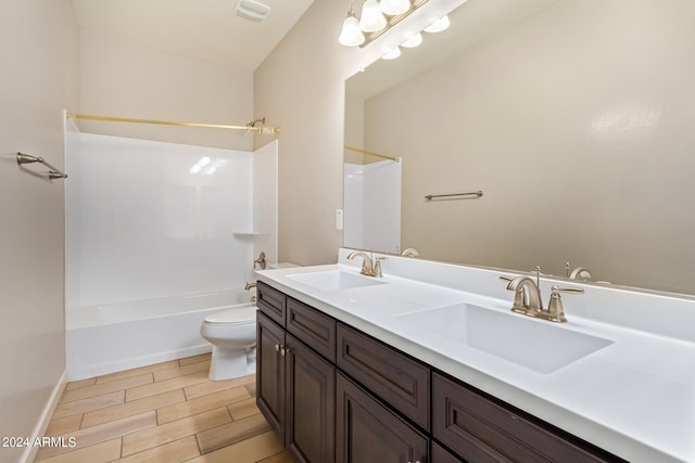 full bathroom featuring toilet, vanity, and tub / shower combination