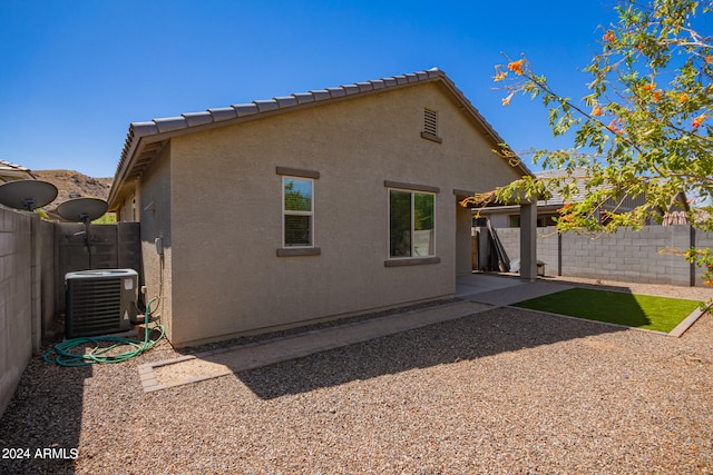 back of house with a patio and cooling unit