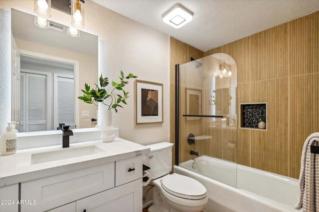 bathroom with enclosed tub / shower combo, a textured ceiling, toilet, vanity, and visible vents