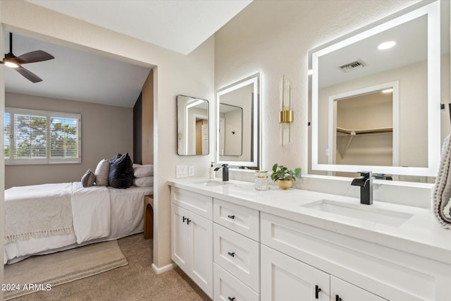 bathroom with visible vents, a sink, ensuite bathroom, and double vanity