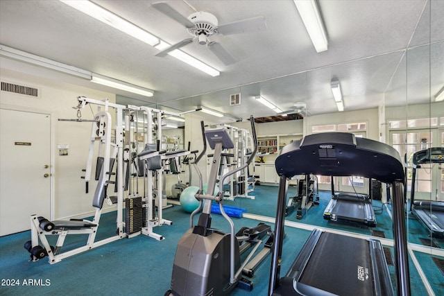 gym with ceiling fan and visible vents