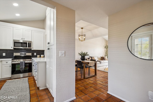 kitchen featuring tasteful backsplash, appliances with stainless steel finishes, white cabinets, and light countertops