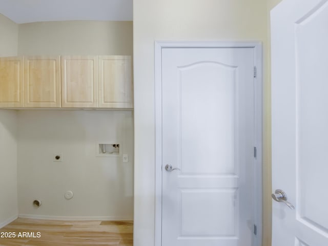 clothes washing area with light wood finished floors, hookup for a washing machine, hookup for a gas dryer, cabinet space, and hookup for an electric dryer