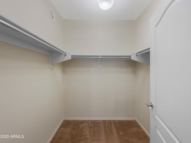 spacious closet featuring dark carpet and visible vents