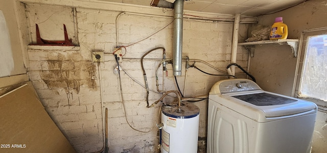 laundry area featuring washer / dryer, water heater, and laundry area