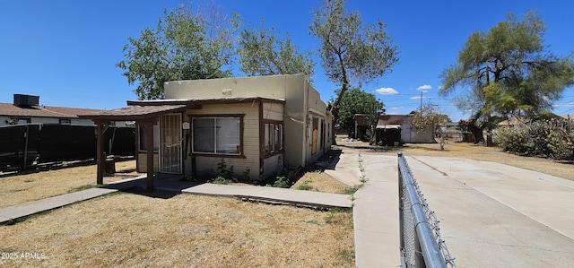 view of front of house with fence and cooling unit