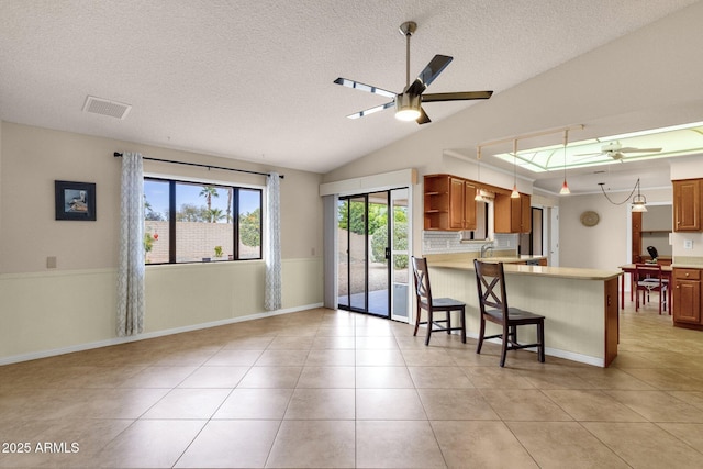 kitchen with open shelves, visible vents, ceiling fan, and light tile patterned floors