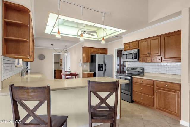 kitchen featuring open shelves, a sink, stainless steel appliances, crown molding, and brown cabinets