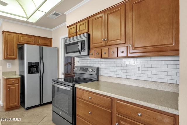 kitchen featuring brown cabinetry, visible vents, appliances with stainless steel finishes, and ornamental molding