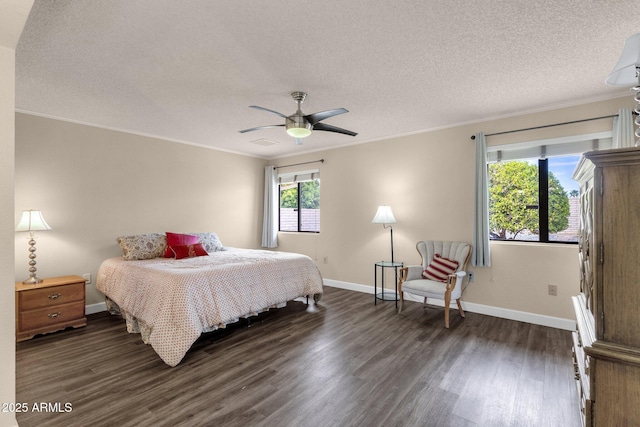 bedroom with visible vents, baseboards, dark wood finished floors, a textured ceiling, and crown molding