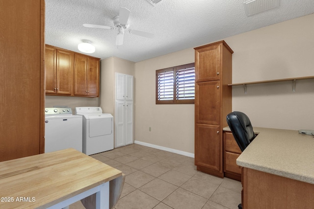 clothes washing area with visible vents, cabinet space, light tile patterned floors, ceiling fan, and washing machine and clothes dryer