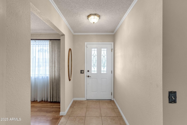 foyer featuring crown molding, a textured wall, a wealth of natural light, and a textured ceiling