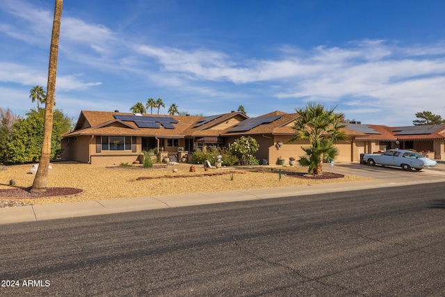 ranch-style house with solar panels