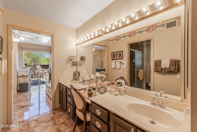 bathroom featuring ceiling fan, toilet, vanity, and walk in shower