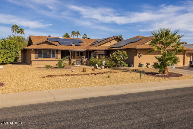 ranch-style home with solar panels