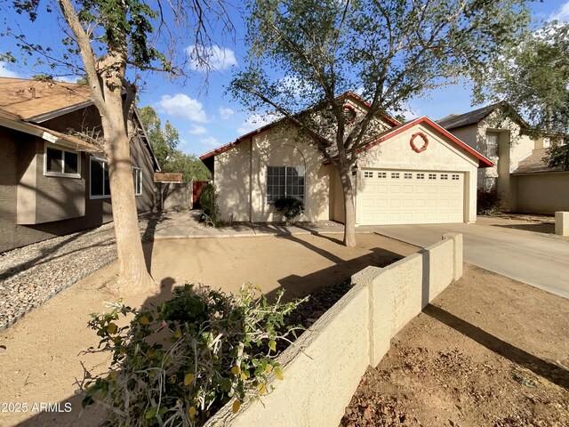 10242 N 66th Ave, Glendale, AZ 85302 - view of front of home featuring stucco siding, an attached garage, and driveway