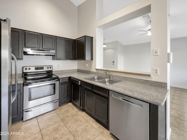 10242 N 66th Ave, Glendale, AZ 85302 - kitchen featuring stainless steel appliances, a sink, light tile patterned floors, ceiling fan, and a towering ceiling