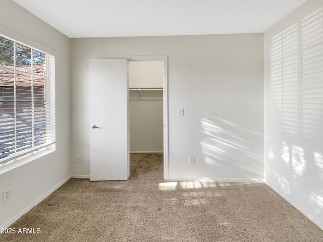 10242 N 66th Ave, Glendale, AZ 85302 - unfurnished bedroom featuring carpet floors, a walk in closet, a closet, and baseboards
