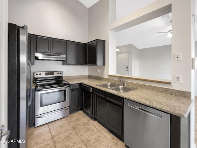 10242 N 66th Ave, Glendale, AZ 85302 - kitchen featuring stainless steel appliances, under cabinet range hood, a sink, a high ceiling, and light tile patterned floors