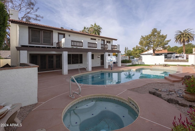 view of pool featuring an in ground hot tub and a patio area