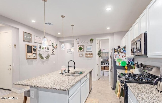 kitchen with sink, white cabinetry, hanging light fixtures, a kitchen island with sink, and appliances with stainless steel finishes