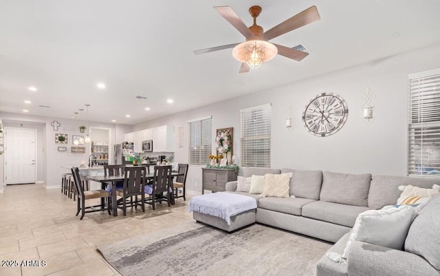 tiled living room featuring ceiling fan