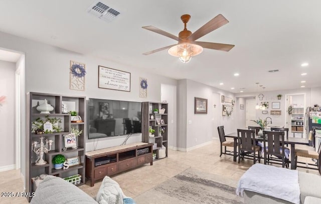 living room featuring ceiling fan and light tile patterned floors