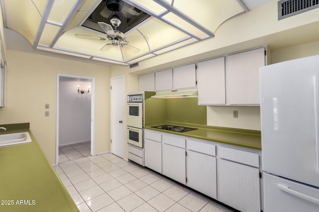 kitchen featuring white appliances, a ceiling fan, visible vents, light tile patterned flooring, and under cabinet range hood