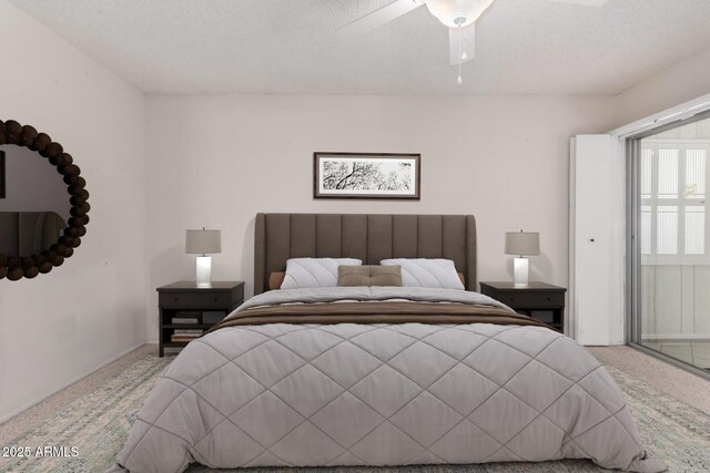 bedroom featuring light colored carpet and a ceiling fan