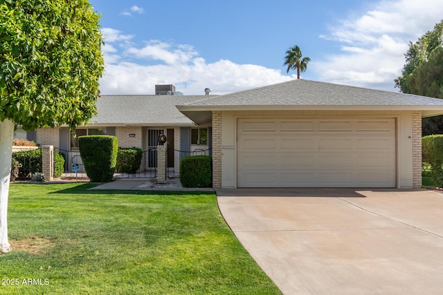 single story home featuring a front yard, an attached garage, a shingled roof, concrete driveway, and brick siding