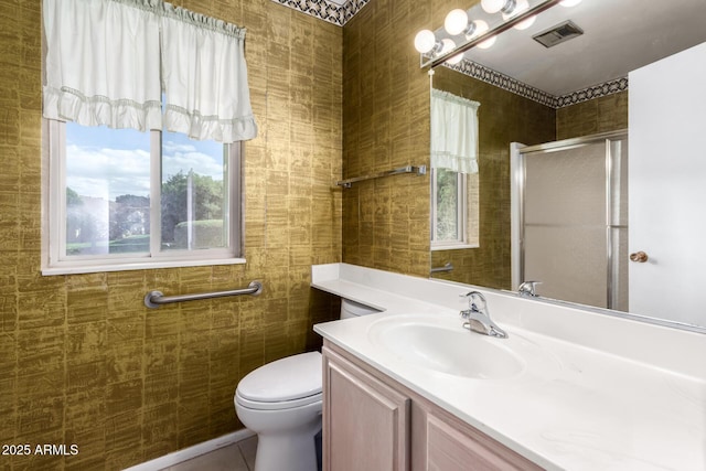 bathroom with visible vents, tile walls, a shower stall, tile patterned flooring, and vanity