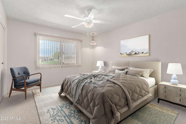 bedroom with light colored carpet, a textured ceiling, and ceiling fan