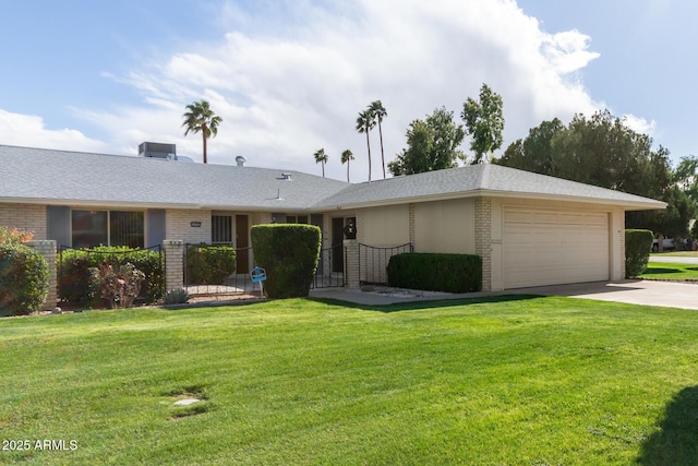 single story home featuring brick siding, an attached garage, driveway, and a front yard