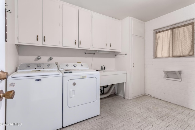 washroom with washer and dryer, cabinet space, and light floors