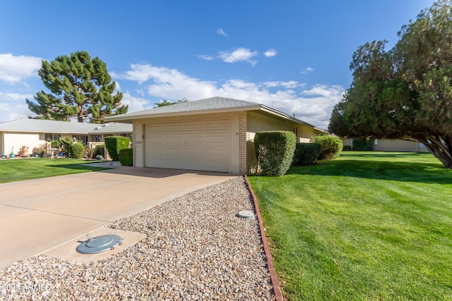 single story home with a garage, driveway, brick siding, and a front yard