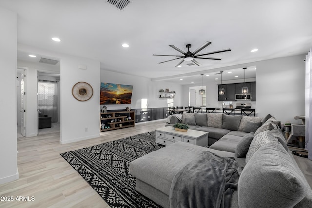 4352 N 91st Gln, Phoenix, AZ 85037 - living room with light wood-style flooring, ceiling fan, recessed lighting, and baseboards